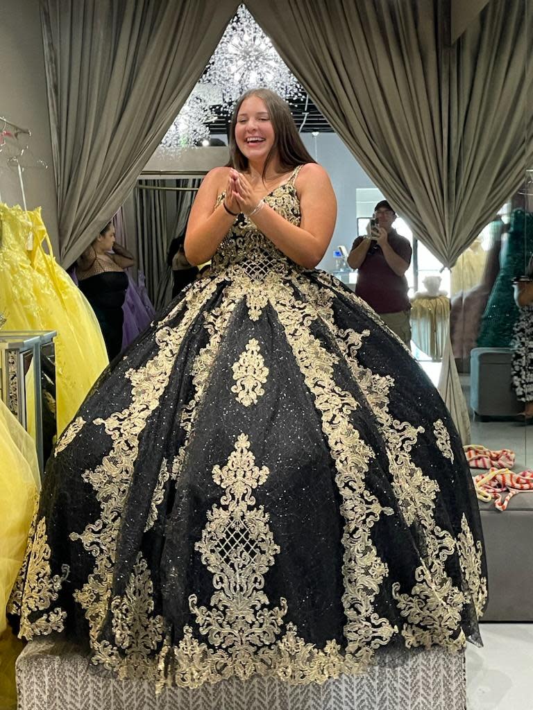 Ashlynn Buller, 14, is seen in this photo from July where she selected a dress she tried on at a store in preparation for her quinceañera. Ashlynn's parents say the Phoenix shop where they ordered the gown from, Oh La La by Posh, and its owner defrauded them as they never received merchandise and the business has since closed down.