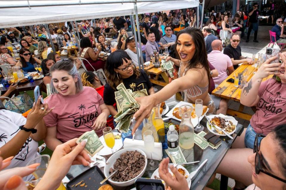 Drag Queen Kat Wilderness collects tips from guests after a performance during a Drag Brunch at R House Wynwood.