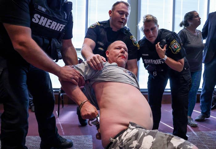 Authorities arrest a man after a fight broke out during the Loudoun County School Board meeting over protests against critical race theory and transgender students' rights.