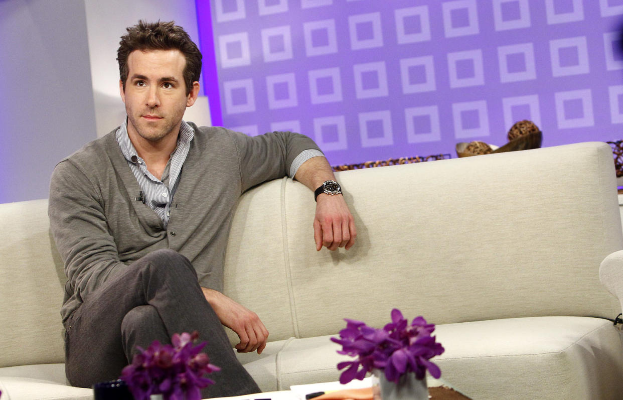 Reynolds in a grey cardigan sits on a white couch on the set of TODAY. (eter Kramer / NBCUniversal via Getty Images)