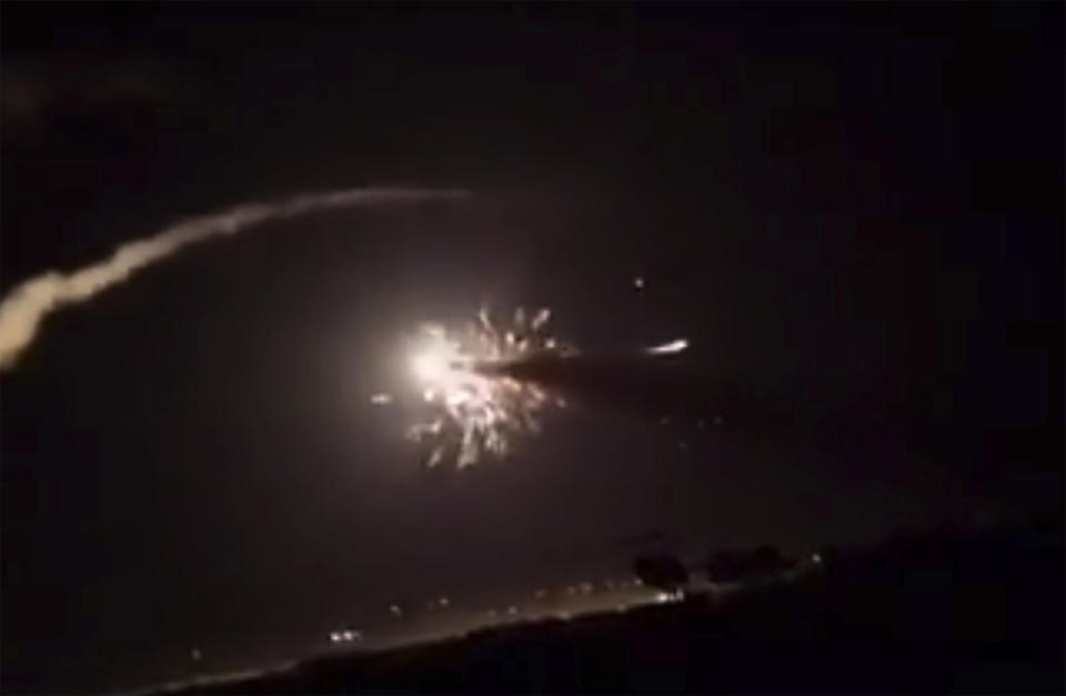 This frame grab from a video provided by the Syrian official news agency SANA shows missiles flying into the sky near Damascus, Syria, Tuesday, Dec. 25, 2018. Israeli warplanes flying over Lebanon fired missiles toward areas near the Syrian capital of Damascus late Tuesday, hitting an arms depot and wounding three soldiers, Syrian state media reported, saying that most of the missiles were shot down by air defense units. (SANA via AP)