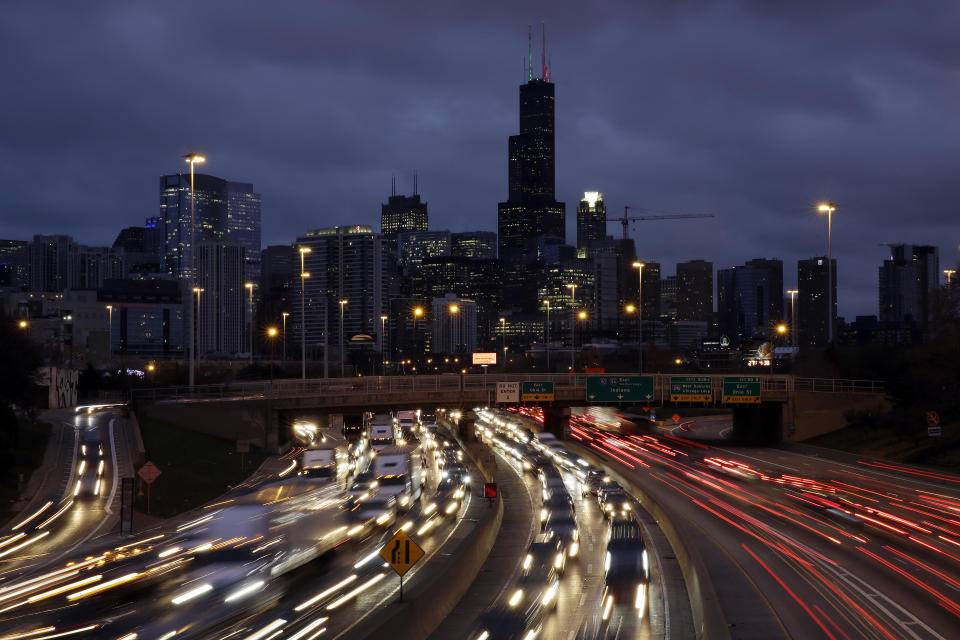 In this photo taken with a long exposure, traffic streaks across the John F. Kennedy Expressway at the start of the Thanksgiving holiday weekend, Wednesday, Nov. 21, 2018, in Chicago. Mild weather and falling gasoline prices are helping Thanksgiving travelers get where they're going while saving a few bucks. (AP Photo/Kiichiro Sato)