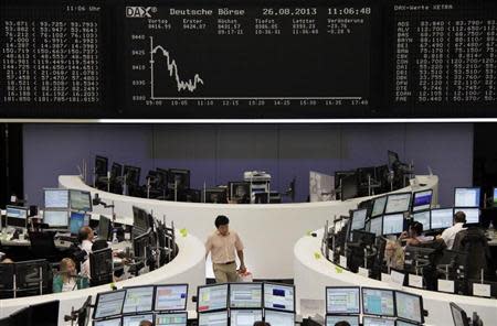 Traders are pictured at their desks in front of the DAX board at the Frankfurt stock exchange August 26, 2013. REUTERS/Remote/stringer