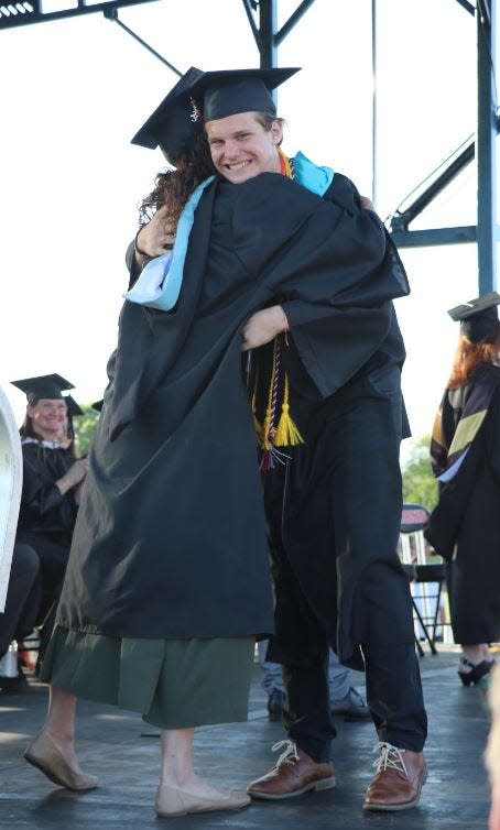 Aidan Whitehead receives a hug after receiving his diploma Thursday during Sturgis High School's 2023 commencement exercises.