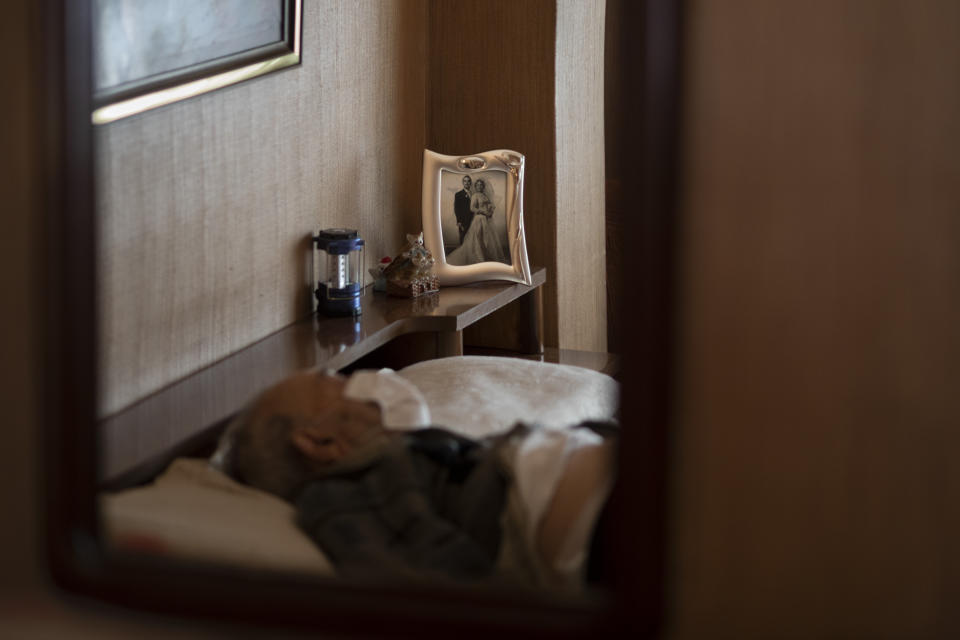 Leopoldo Roman, 85, lies in bed wearing a face mask as he waits for doctors during a home medical visit in Barcelona, Spain, April 3, 2020. Roman, whose leg was amputated years ago, has to pay for daily care out of his pension since the public system only provides for a social worker to come for an hour a day, three days a week. The image was part of a series by Associated Press photographer Emilio Morenatti that won the 2021 Pulitzer Prize for feature photography. (AP Photo/Emilio Morenatti)