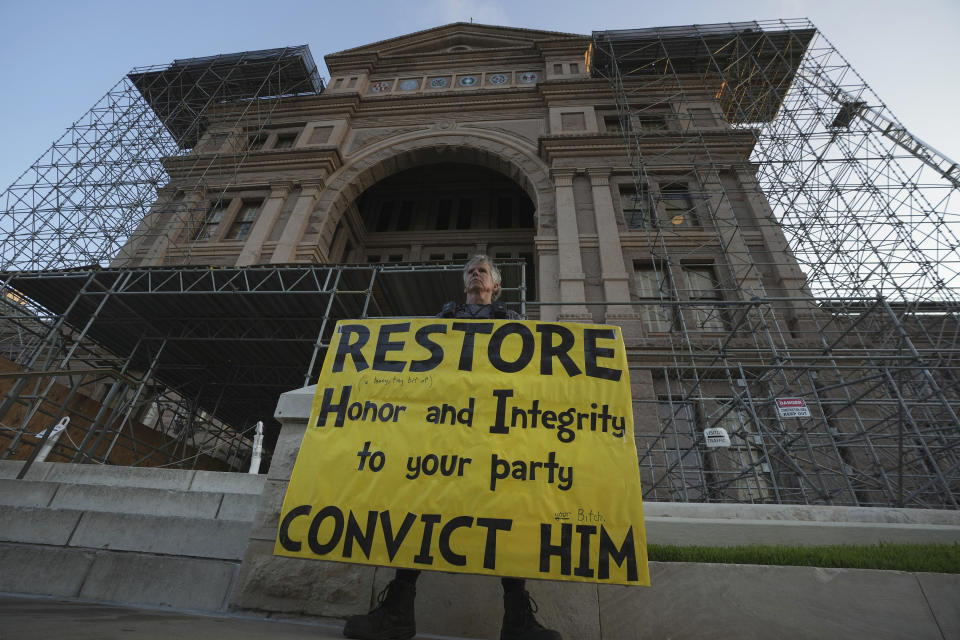 Gordon Jones of Dallas with a sign outside the Texas State Capital in Austin, Tuesday, Sept. 5, 2023. The historic impeachment trial of Texas Attorney General Ken Paxton begins today and will determine whether the embattled Republican, who is an ally of former President Donald Trump, is ousted from office after years of scandal and corruption accusations. (AP Photo/LM Otero)