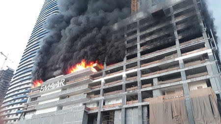 A fire is seen at a tower under construction in Dubai's Downtown district, United Arab Emirates April 2, 2017. Government of Dubai Media Office/Handout via REUTERS