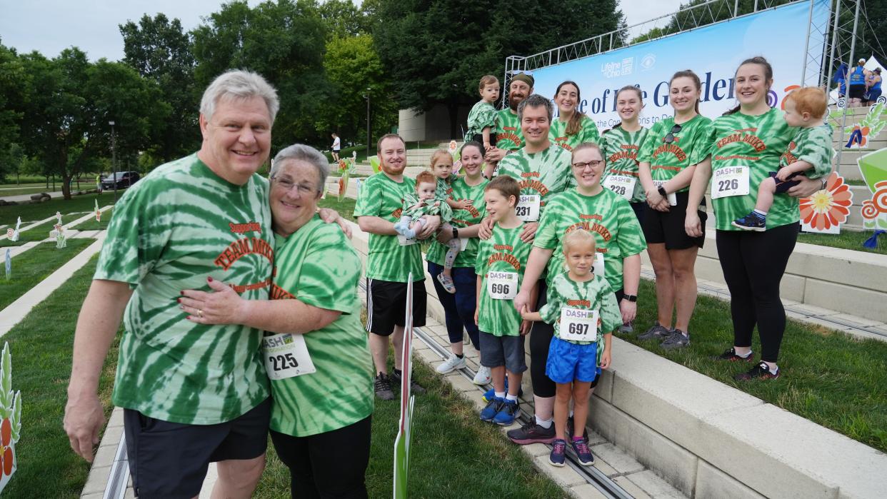 Mike Kaster, left, of Carmel, Indiana, was a COVID-19 patient who needed a double lung transplant. He participated Saturday in the Lifeline of Ohio Dash for Donation in Columbus. Almost his entire family turned out for the event, including wife Joan and (front row, from left) Matt, Oliver, 5 months, Valarie, 3, and Hannah Kaster; Craig and Patti Oldis, with Johnathan, 8, and Abigail, 6. In the back row is William, 20 months, Michael and Liz Kaster; Megan Kaster; Bridget Kaster; and Margaret Kaster, with Lucas Roach, 1.