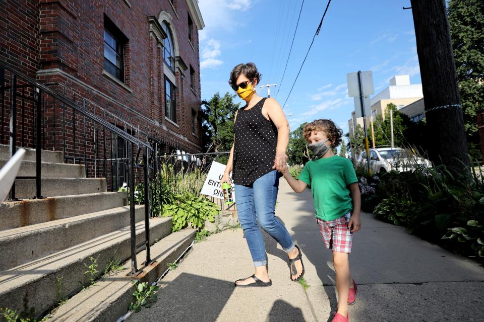 Rebecca Beebe drops her 5-year-old son, Truman, off at child care at University Avenue Discovery Center in Madison, Wis., on Aug. 13.