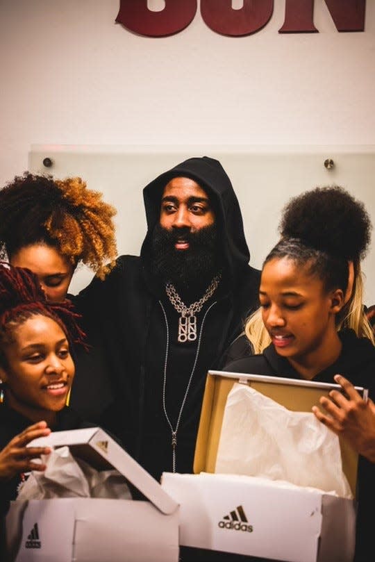 Feb. 16, 2023; James Harden stand among Arizona State women's basketball teammates as they open boxes of his adidas shoes