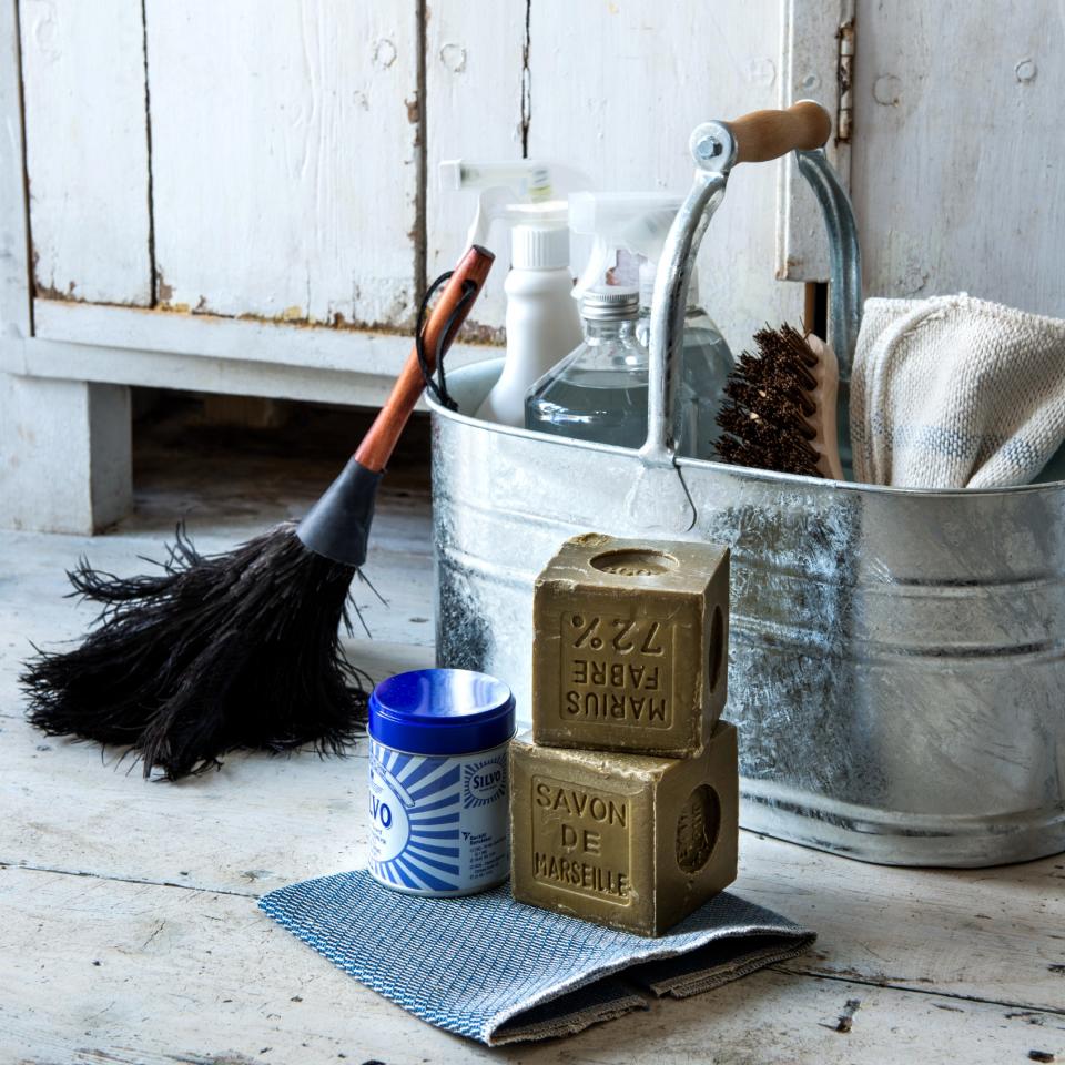 A bucket with cleaning products and tools