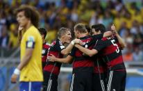 Germany's players celebrate their goal against Brazil during their 2014 World Cup semi-finals at the Mineirao stadium in Belo Horizonte July 8, 2014. REUTERS/Marcos Brindicci