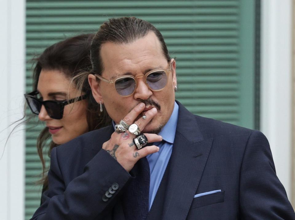 Depp smokes outside court during the defamation trial against ex-wife Amber Heard (Getty Images)