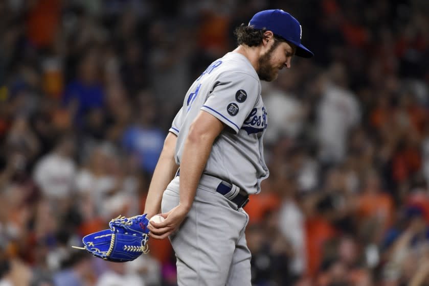 Dodgers starting pitcher Trevor Bauer walks back to the mound with his head down after giving up a home run