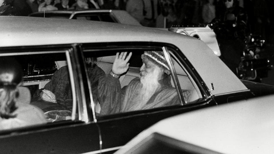 Bhagwan Shree Rajneesh in the back of a Rolls-Royce from his car collection. - Credit: Photo: Don Ryan/AP/Shutterstock
