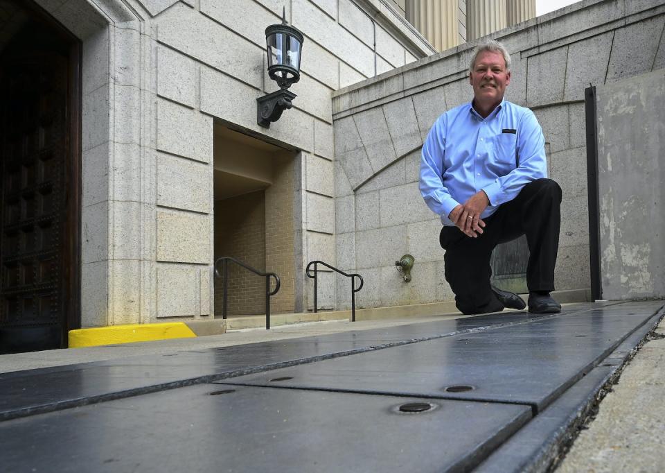 Tim Edwards, facility manager for the National Archives, with the flood control gate system that kept a 2019 storm from flooding the building in Washington, DC. <a href="https://www.gettyimages.com/detail/news-photo/tim-edwards-facility-manager-for-the-national-archives-with-news-photo/1155241152" rel="nofollow noopener" target="_blank" data-ylk="slk:Bill O'Leary/The Washington Post via Getty Images;elm:context_link;itc:0;sec:content-canvas" class="link ">Bill O'Leary/The Washington Post via Getty Images</a>