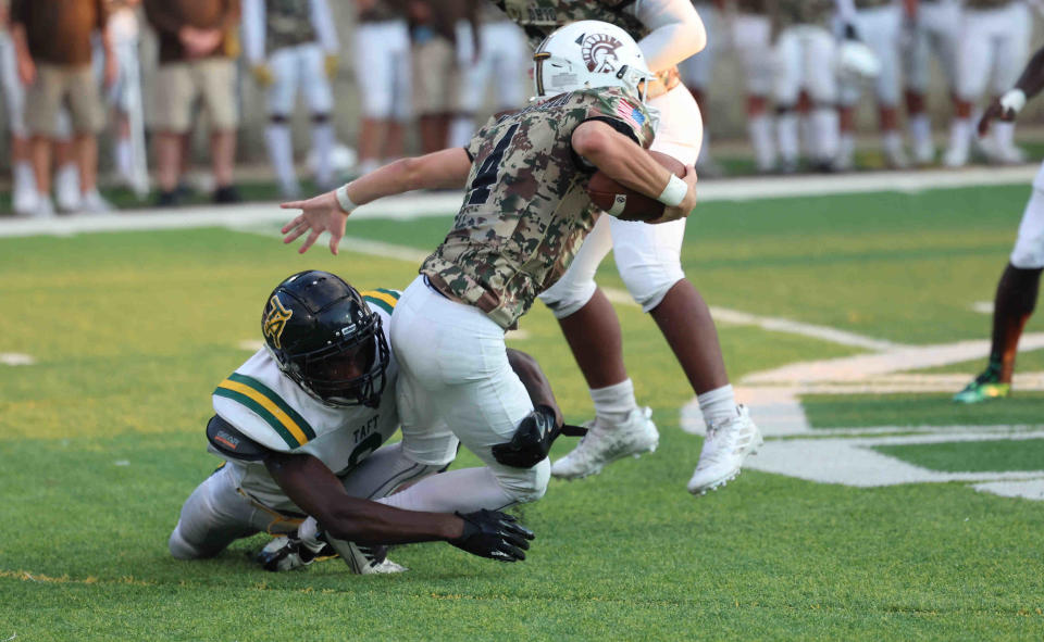 Roger Bacon quarterback Jimmy Mumper (4) is sacked by Taft players Elias Rudolph (9)  during their game Thursday, Aug. 18, 2022.