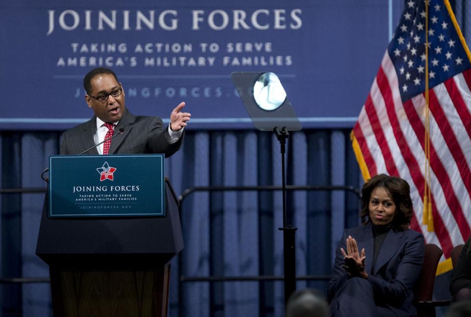 First lady Michelle Obama applauds as Larry Melton, left, a Marine Corps veteran and project executive for Bechtel, speaks at a National Symposium on Veterans’ Employment in Construction, hosted by the Labor, Department of Labor, Monday, Feb. 10, 2014, in Washington. Mrs. Obama said a construction industry pledge to hire 100,000 veterans by 2019 isn't only the right and patriotic thing to do, but also a smart thing for business. (AP Photo/Manuel Balce Ceneta)