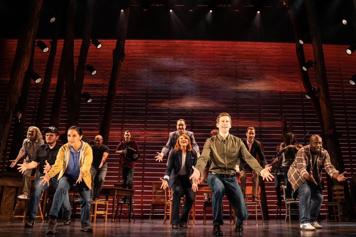 Sharone Sayegh (front left, in blue shirt and yellow jacket) with the ensemble in the North American tour of “Come From Away”