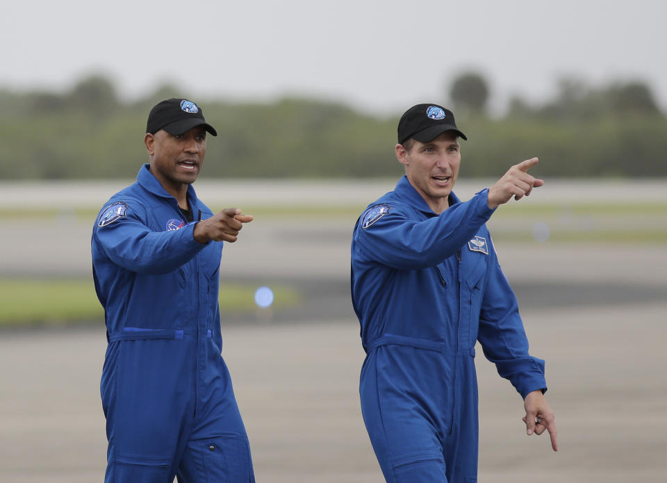 NASA Astronauts Victor Glover and Michael Hopkins walk from their airplane after arriving at the Kennedy Space Center, Sunday, Nov. 8, 2020, in Cape Canaveral, Fla. Four astronauts will fly on the SpaceX Crew-1 mission to the International Space Station scheduled for launch on Nov. 14, 2020 (AP Photo/Terry Renna)