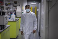 Britian's Chancellor of the Exchequer Rishi Sunak walks, during a visit to Imperial Clinic Research Facility at Hammersmith Hospital, where he met staff and was instructed on research techniques, to mark the announcement of his Spending Review, in London, Wednesday, Nov. 25, 2020. (Jack Hill/Pool Photo via AP)