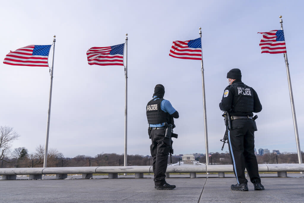 A year after the attack on the U.S. Capitol, U.S. Park Police stand along the National Mall in Washington, D.C. (AP Photo/Jacquelyn Martin)