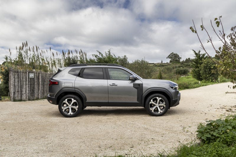 Side view of a Dacia Duster parked on some dirt