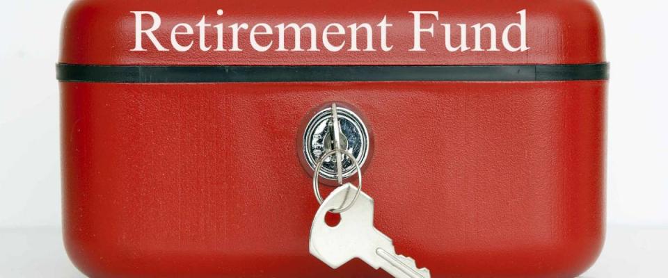 A closed red metal cash tin with Retirement Fund notice against a white background