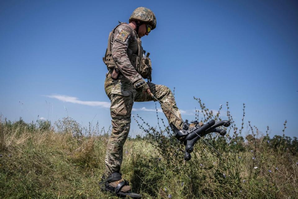 A Ukrainian ‘sapper’ wears “spider boots” to minimise potential injuries from the mines they are tasked with clearing (REUTERS/Viacheslav Ratynskyi)