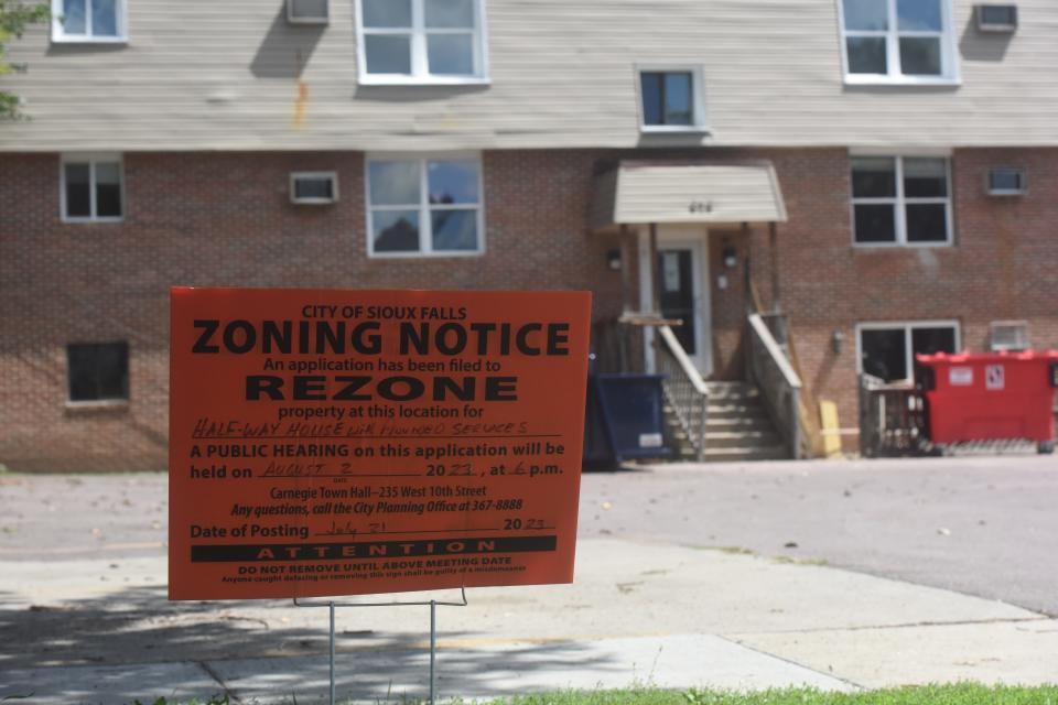 A sign notifying neighbors of the potential rezoning of an All-Saints apartment building into a halfway house.
