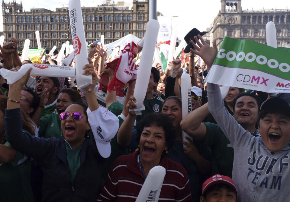 Mexico fans celebrate their team’s goal against Germany during soccer World Cup match, in Mexico City’s Zocalo, Sunday, June 17. Mexico won it’s first match against Germany 1-0. (AP Photo/Anthony Vazquez)