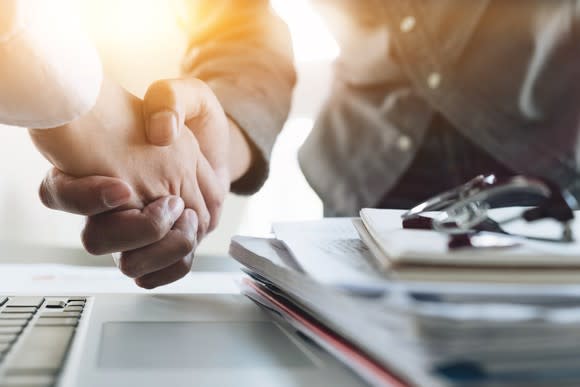 Two businesspeople shaking hands.