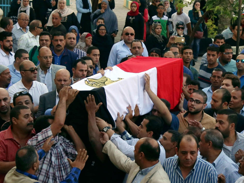 The coffin of police captain Ahmed Fayez, killed in the battle in al-Wahat al-Bahriya, is carried: AP