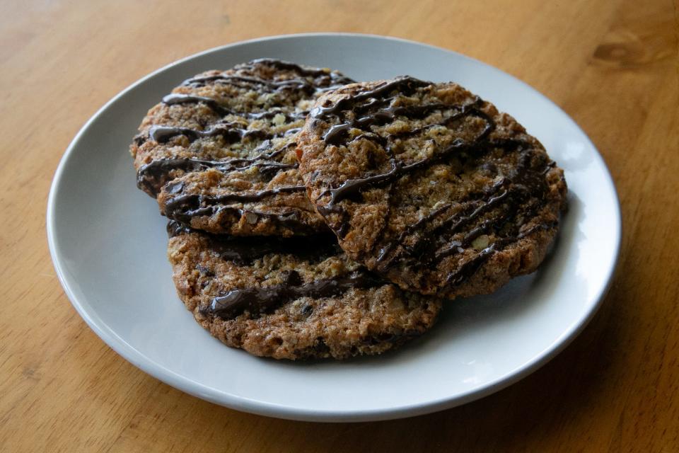 A plate of cowboy cookies are on display at Sugarbaker's Friday, Aug. 25, 2023. The cookies contain oatmeal, chocolate chips, coconut, pecans and are drizzled with chocolate and topped with sea salt.
