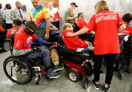 Protesters, mostly handicapped, line the hallway outside the Senate Finance Committee hearing room hours ahead a hearing on the latest Republican effort to repeal Obamacare on Capitol Hill in Washington, U.S., September 25, 2017. REUTERS/Kevin Lamarque