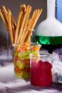 <p>Instead of serving guac and hummus in a regular old bowl, buy test tubes from your local craft store to create a mad scientist-inspired setting.</p>