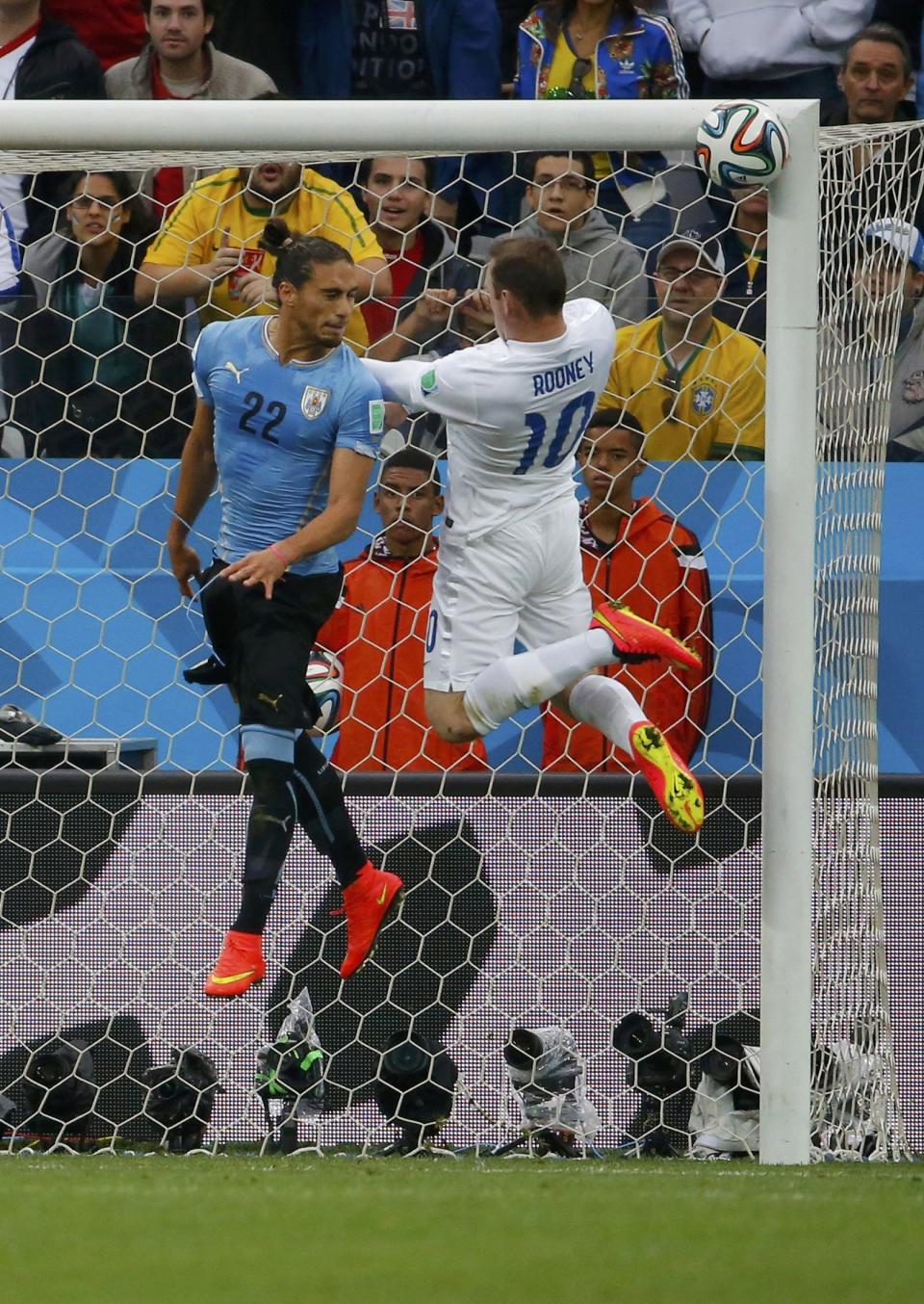 England's Rooney heads the ball into the crossbar during the 2014 World Cup Group D soccer match between Uruguay and England in Sao Paulo