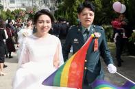 Chen Ying-Hsuan, a combat engineer lieutenant, and her wife Li Chen-Chen, are seen during a military mass wedding in Taoyuan