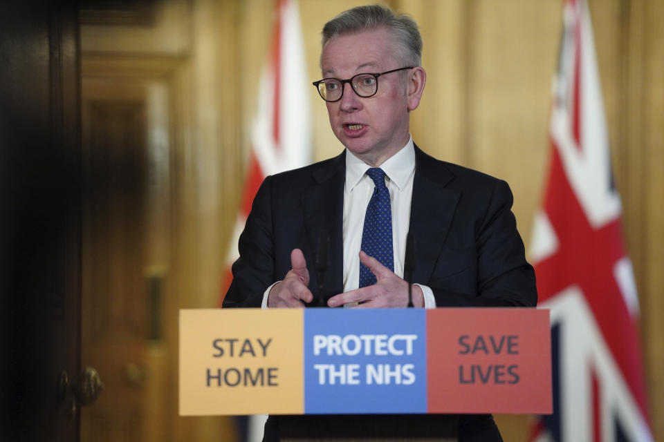 In this image made available by British government because no media allowed into 10 Downing Street because of the coronavirus pandemic, showing British lawmaker Michael Gove holding a Digital Press Conference on COVID-19, in 10 Downing Street, London, Friday March 27, 2020. Prime Minister Boris Johnson has tested positive for the COVID-19 coronavirus Friday along with other members of the government, and has self isolated. (Pippa Fowles / No 10 Downing Street via AP)