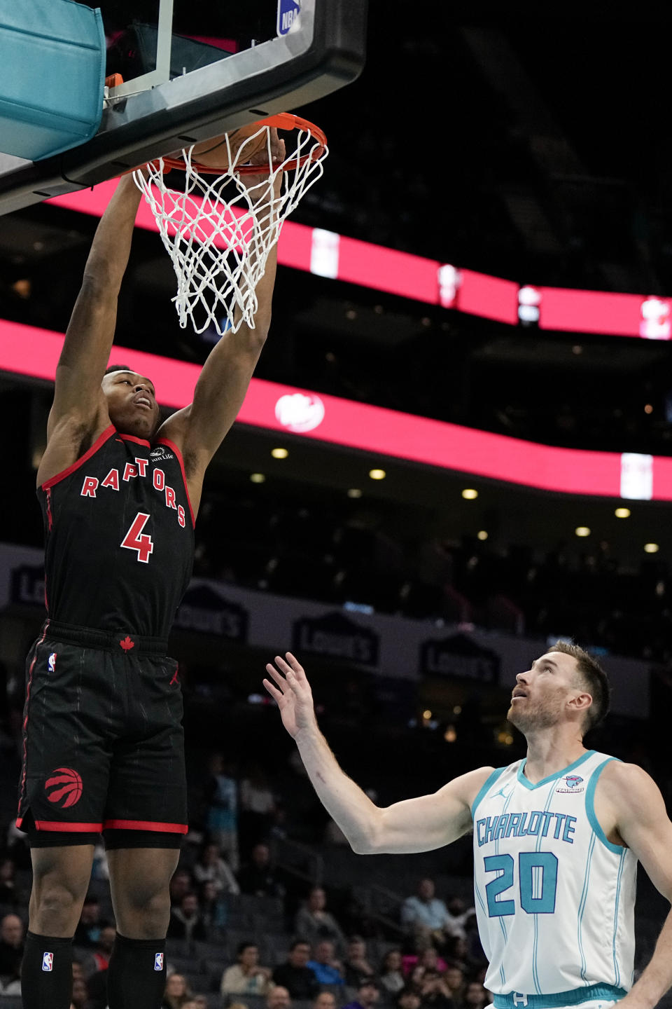 Toronto Raptors forward Scottie Barnes dunks over Charlotte Hornets forward Gordon Hayward during the first half of an NBA basketball game Friday, Dec. 8, 2023, in Charlotte, N.C. (AP Photo/Chris Carlson)