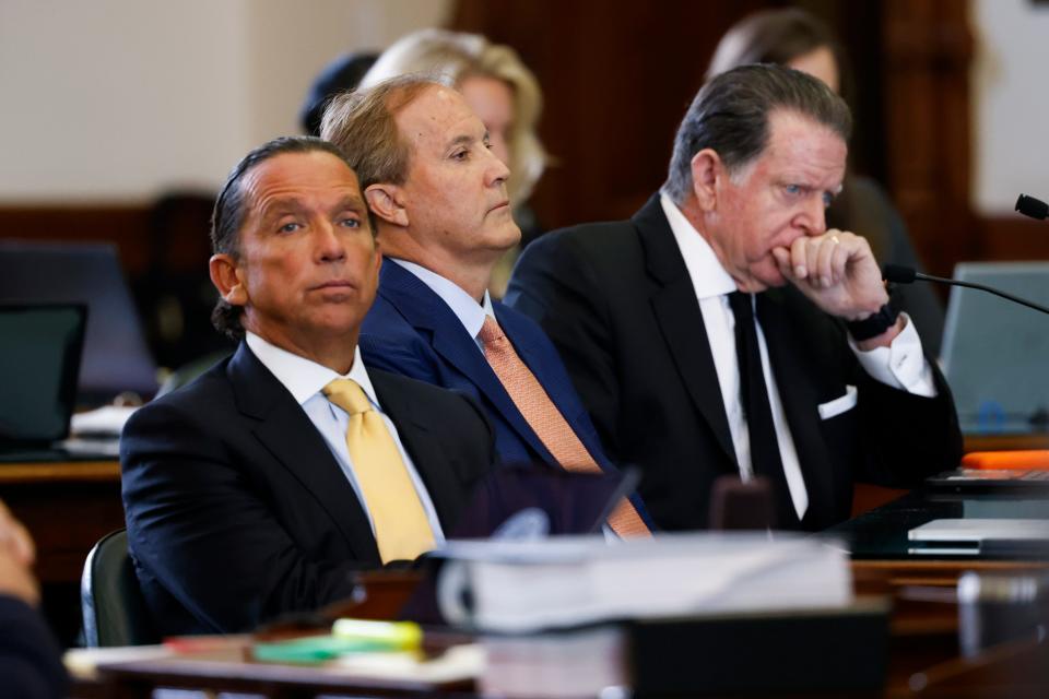 Texas Attorney General Ken Paxton (center) sits with his lawyers Tony Buzbee (left) and Dan Cogdell (right) at the beginning of the first day of Paxton’s impeachment trial in the Texas Senate chambers at the Texas State Capitol in Austin on Tuesday, Sept. 5, 2023. The Texas House, including a majority of its GOP members, voted to impeach Paxton for alleged corruption in May. (Juan Figueroa/Pool via The Dallas Morning News)