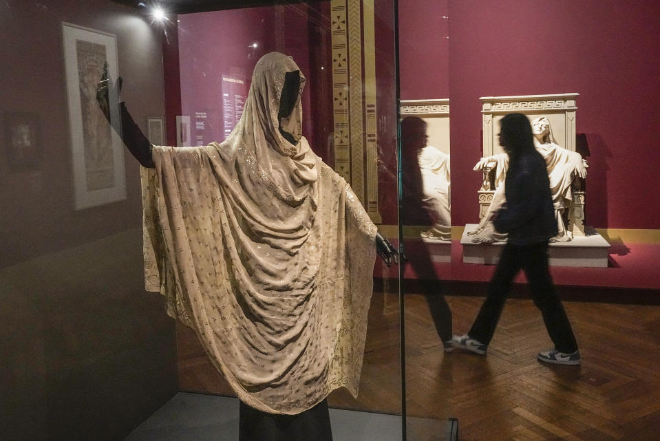 A dress worn by Sarah Bernhardt is displayed during the "Sarah Bernhardt, and the woman created the star" exhibition at the Petit Palais museum in Paris, Friday, April 28, 2023. Inside Paris’ Petit Palais museum, the public is now discovering the madcap jigsaw puzzle of gothic stories, costumes, recordings, films, photos, jewels, sculptures, and personal objects for the first time together that made the unclassical beauty the object of fascination from Berlin, to London and New York. (AP Photo/Michel Euler)