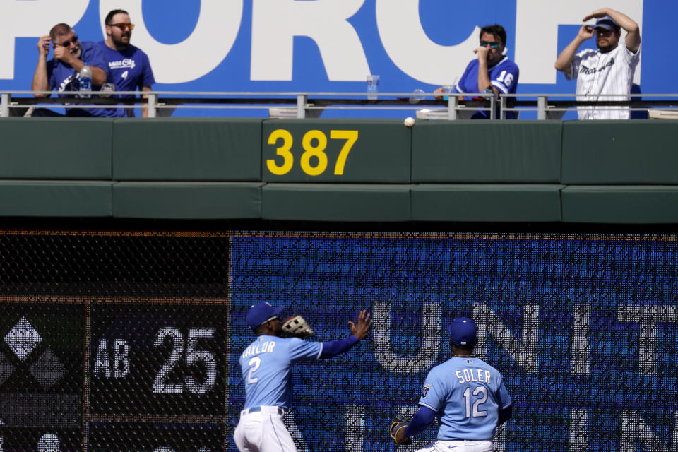 Kansas City Royals center fielder Michael A. Taylor (2) and right fielder Jorge Soler (12) chase after a double by Cleveland Indians' Rene Rivera during the ninth inning of a baseball game Thursday, May 6, 2021, in Kansas City, Mo. (AP Photo/Charlie Riedel)