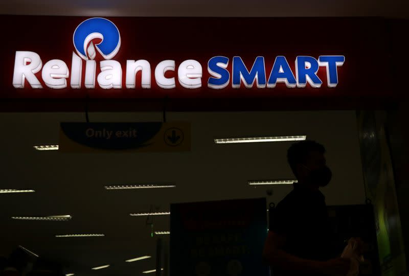 A man leaves a Reliance supermarket in Mumbai
