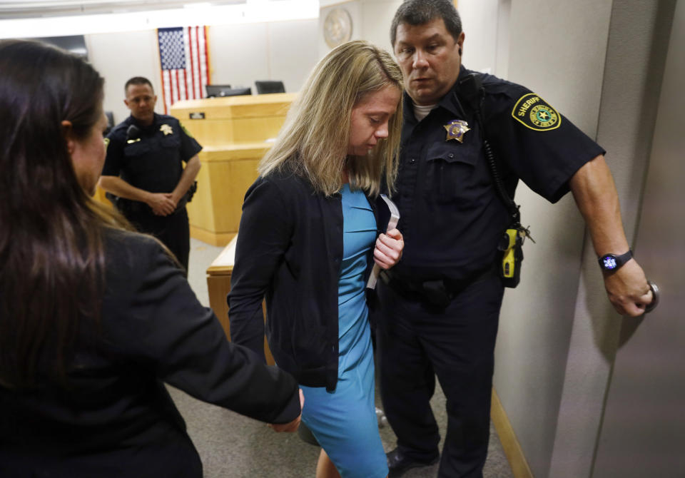 Holding a Bible given to her by State District Judge Tammy Kent, former Dallas Police Officer Amber Guyger leaves court for jail following her sentencing, Wednesday, Oct. 2, 2019, in Dallas. Guyger, who said she mistook neighbor Botham Jean's apartment for her own and fatally shot him in his living room, was sentenced to a decade in prison. (Tom Fox/The Dallas Morning News via AP, Pool)