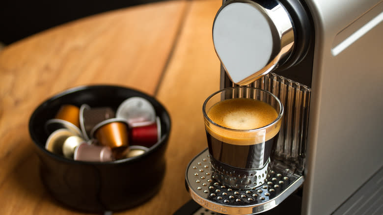 nespresso machine and coffee on table with pods