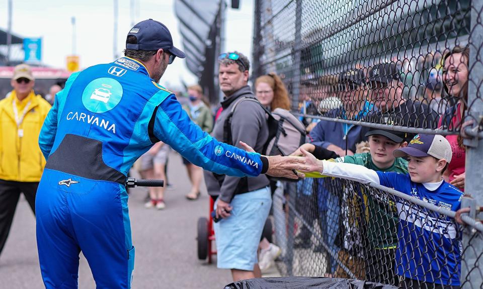 Chip Ganassi Racing driver Jimmie Johnson (48) high fives young racing fans after morning practice before the second session of qualifying for the 106th running of the Indianapolis 500 on Sunday, May 22, 2022, at Indianapolis Motor Speedway, in Indianapolis. 