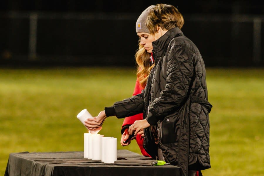 Six candles are lit to remember the deceased during a community prayer vigil, Tuesday, Nov. 14, 2023, at the Tuscarawas Valley Schools football stadium in Zoarville, Ohio. A charter bus filled with high school students was rear-ended by a semitruck on an Ohio highway earlier in the day, leaving several people dead and multiple others injured. (Andrew Dolph/Times Reporter via AP)