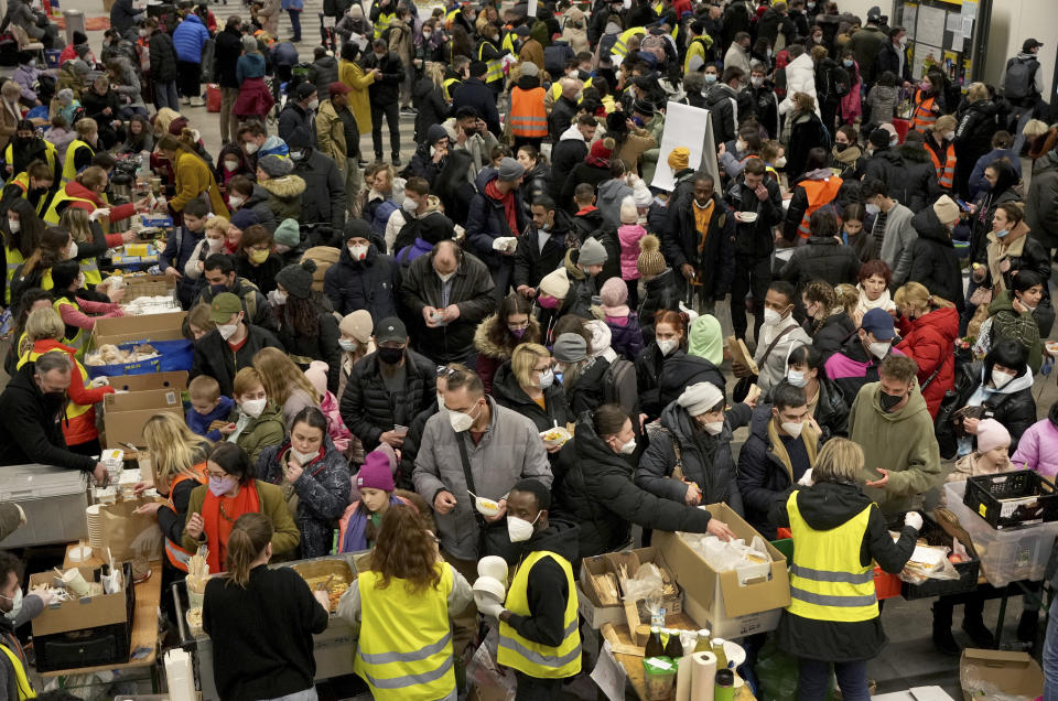 FILE - Ukrainian refugees queue for food in the welcome area after their arrival at the main train station in Berlin, Germany, on March 8, 2022. The U.N. refugee agency says more than 4 million refugees have now fled Ukraine following Russia’s invasion, a new milestone in the largest refugee crisis in Europe since World War II. (AP Photo/Michael Sohn)