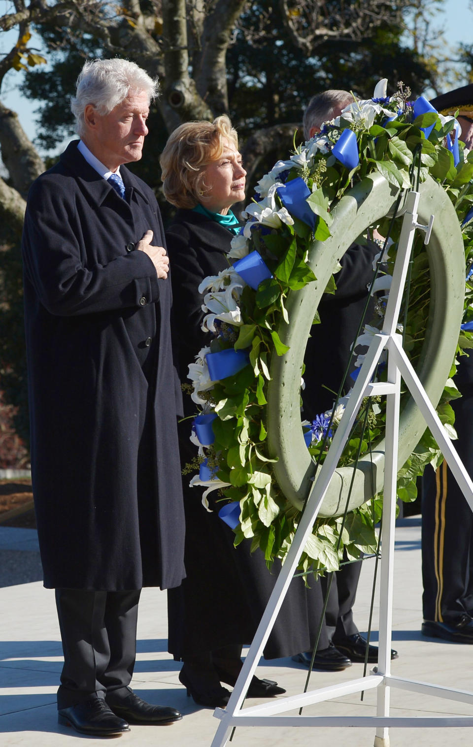 Former U.S. president Bill Clinton and former U.S. Secretary of State Hillary Clinton take part in a wreath-laying ceremony in honor of the late U.S. President John F. Kennedy at Arlington National Cemetery on November 20, 2013 in Arlington, Virginia. (Photo credit should read MANDEL NGAN/AFP/Getty Images)